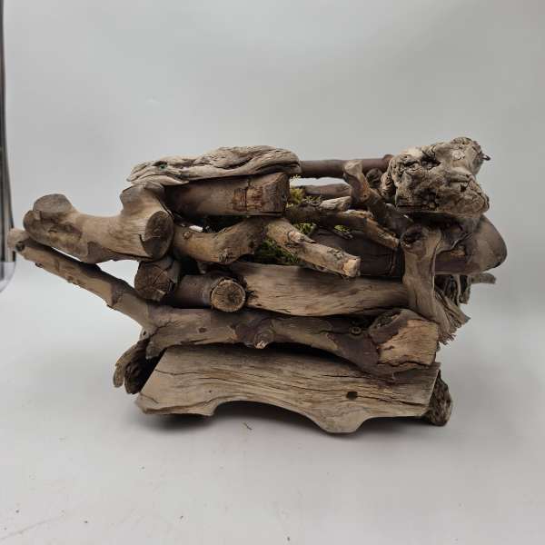 Stacked driftwood planter with small moss accents