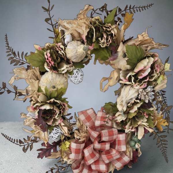 Dried floral wreath with a red plaid bow