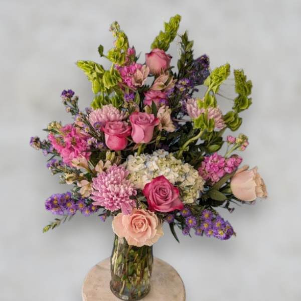 Mixed pink and purple bouquet in a clear glass vase