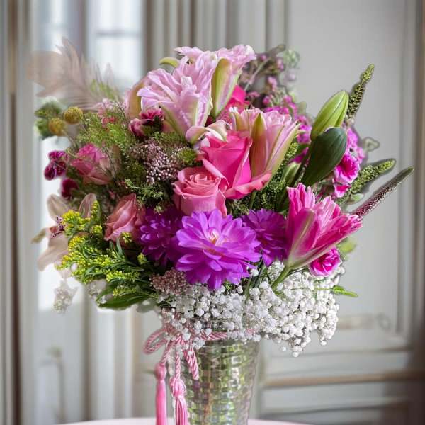 Pink and purple mixed bouquet in a clear glass vase