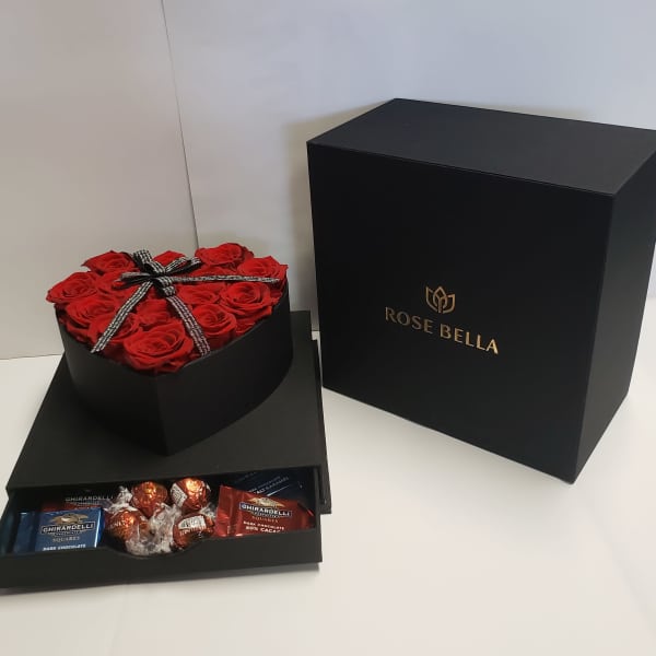 Heart-shaped box of red roses with chocolates in a black gift box