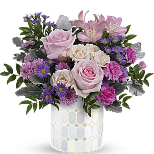 Pink roses and purple flowers in a patterned vase