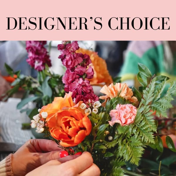 Hands holding a colorful mixed bouquet with orange and pink flowers