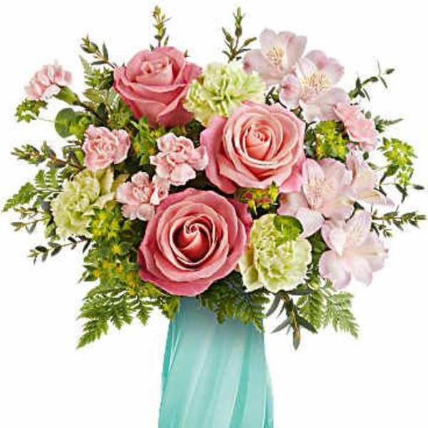 Pink roses and pale flowers in a turquoise vase