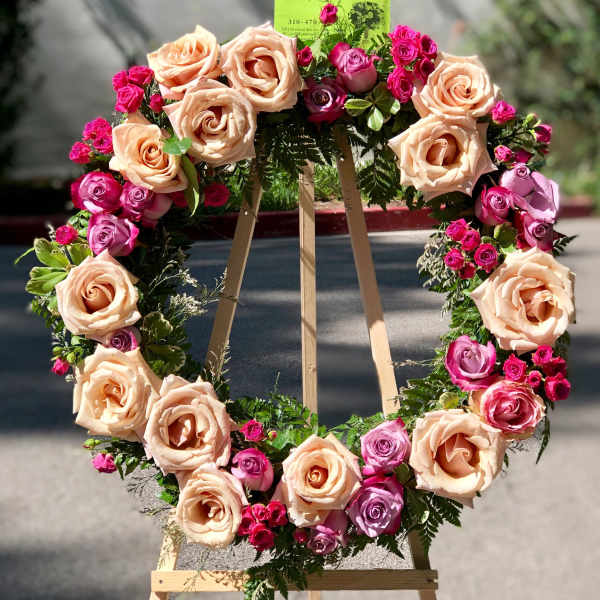 Heart-shaped rose wreath on a wooden easel
