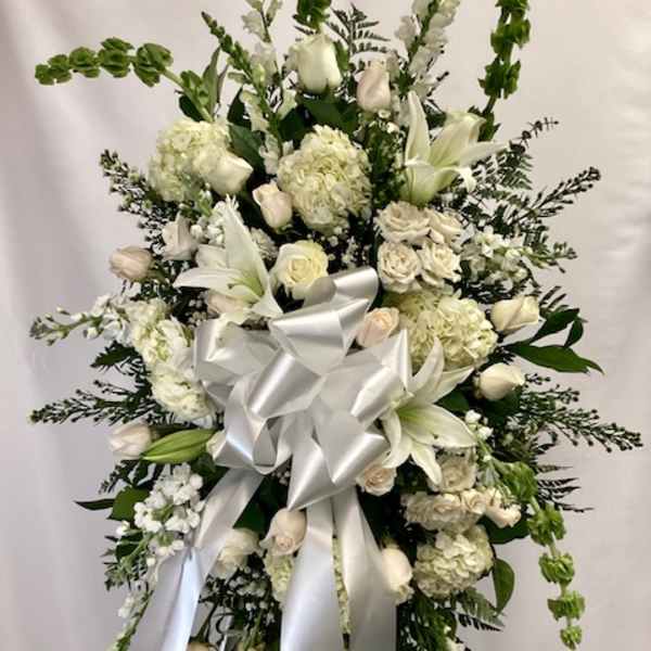 White floral standing spray with a large silver ribbon