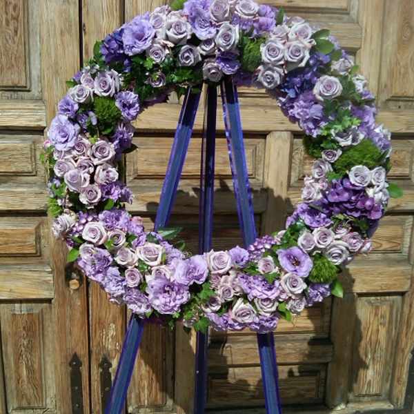 Purple floral wreath on a standing easel