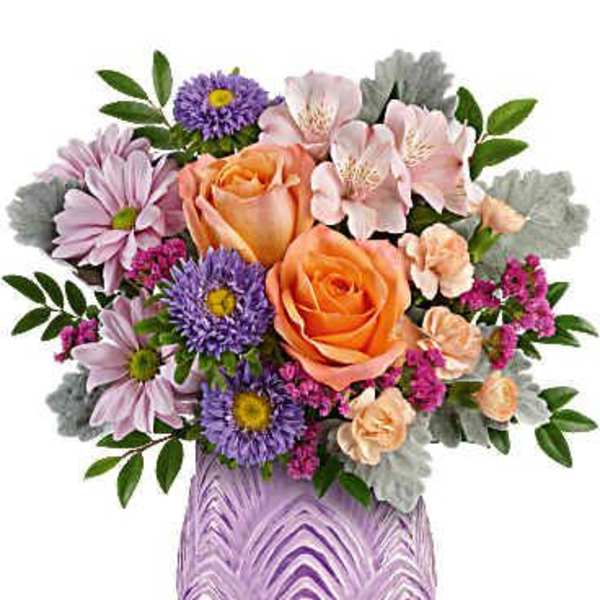 Bouquet of peach roses, purple daisies, and pink alstroemeria in a lavender vase