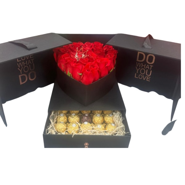 Red roses in a black heart-shaped box with chocolates in a drawer below.