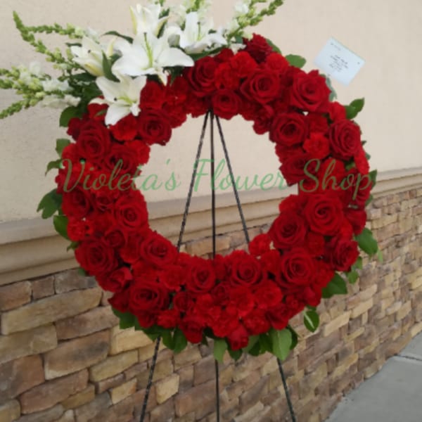 Red rose wreath with white lilies on a standing easel