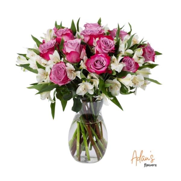Pink roses and white alstroemeria in a clear glass vase