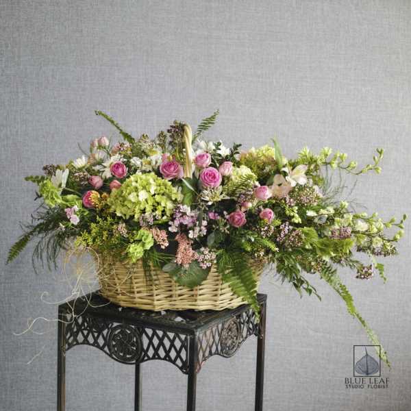 Large basket arrangement with pink roses and mixed blooms