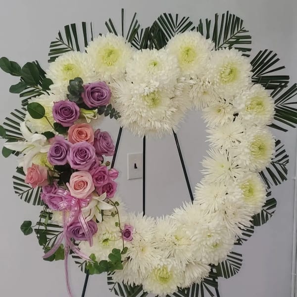 Heart-shaped floral wreath with white chrysanthemums and pink-purple roses