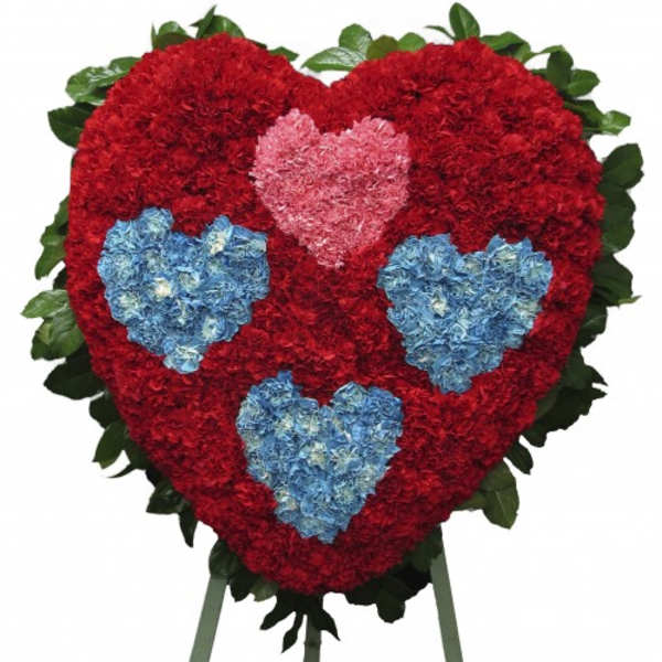 Heart-shaped floral standing spray with red, pink, and blue flowers