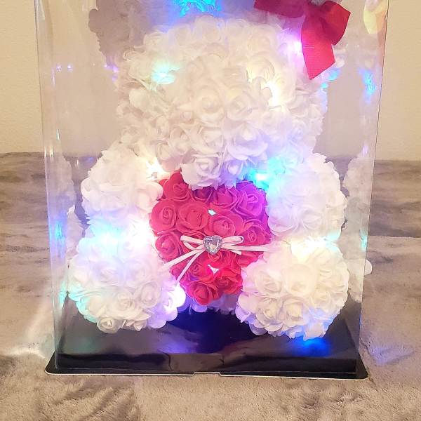 White and pink rose teddy bear in a clear display box with a bow