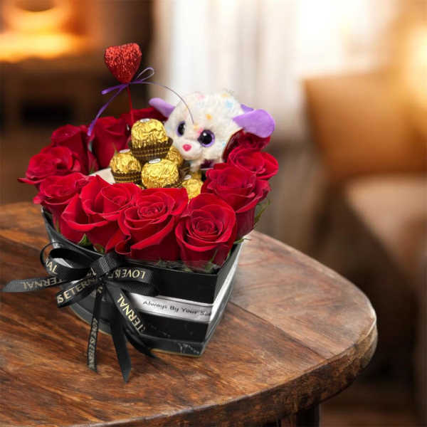 Heart-shaped box of red roses with a plush toy and chocolates