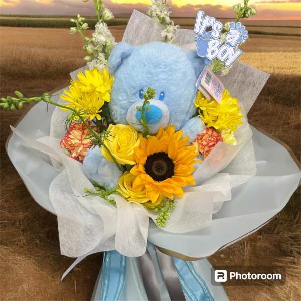 Blue teddy bear bouquet with yellow flowers and a "It's a Boy" topper
