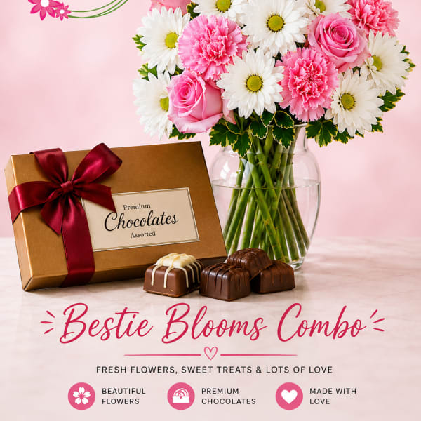 Pink and white flower bouquet in a glass vase with a box of chocolates