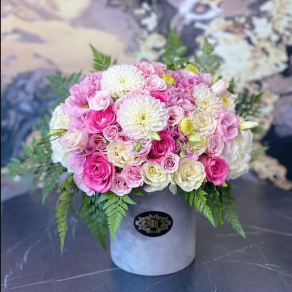 Pink and white rose bouquet in a gray hat box