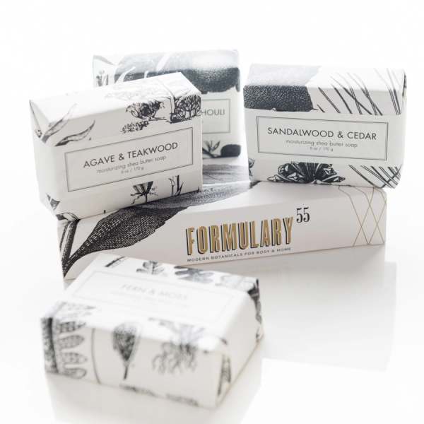 Stacked bars of packaged soap in black-and-white boxes