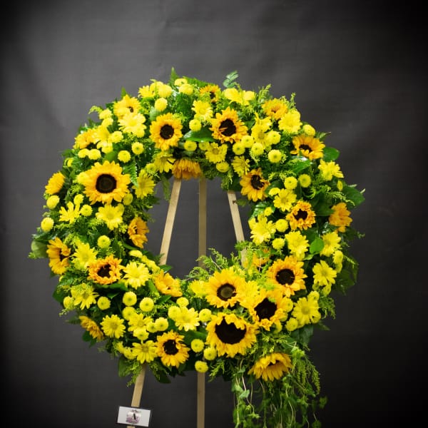 Large yellow floral wreath on a wooden easel