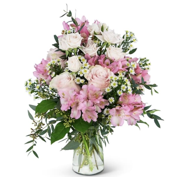 Pink and white mixed flower bouquet in a clear glass vase