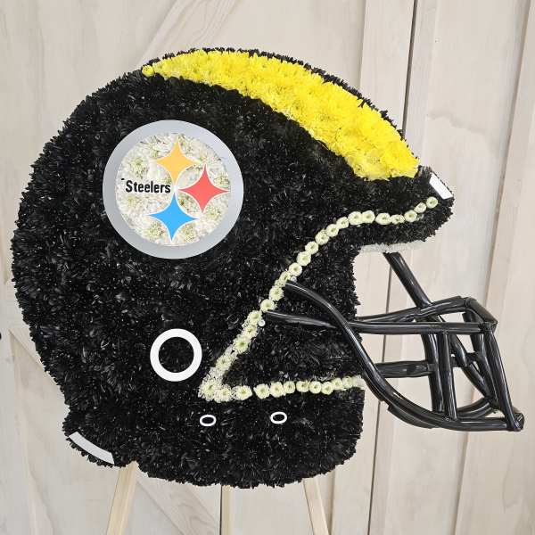 Football helmet-shaped floral tribute in black, yellow, and white