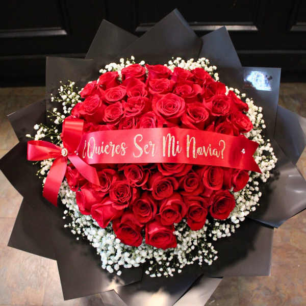 Bouquet of red roses with white baby's breath and a red ribbon