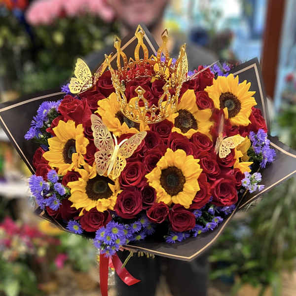 Bouquet of red roses and yellow sunflowers with gold butterfly toppers