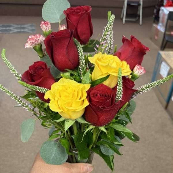 Bouquet of red and yellow roses with a decorative ribbon