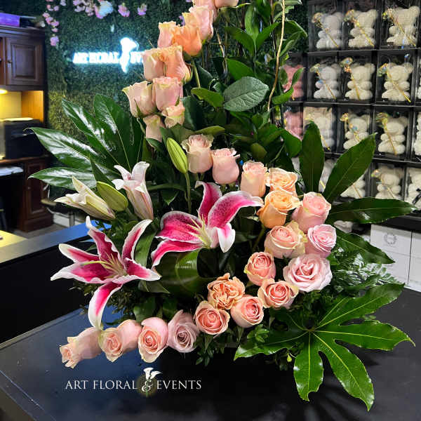Tall floral arrangement with pink roses and pink lilies