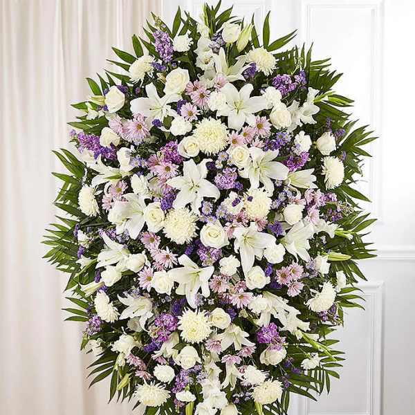 Large standing spray of white and lavender flowers on an easel