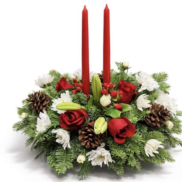 Holiday centerpiece with red candles, red roses, and white flowers