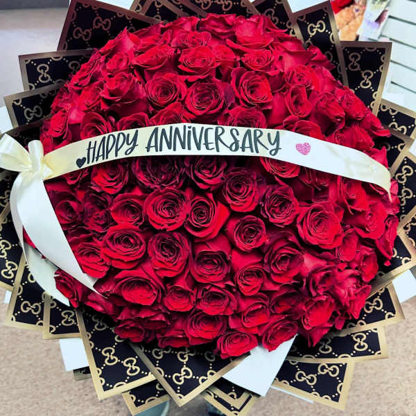 Large bouquet of red roses with a Happy Anniversary ribbon