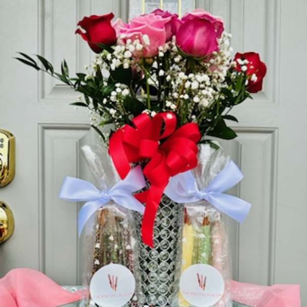 Bouquet of red and pink roses with baby's breath in a wrapped gift set