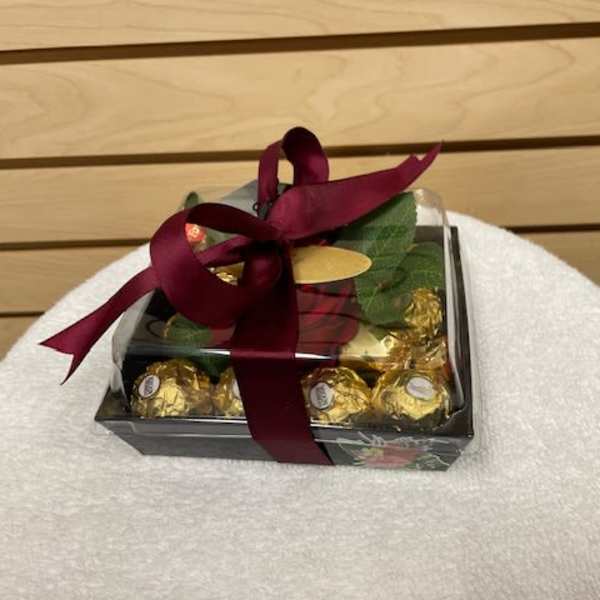 Gift box of chocolates tied with a burgundy ribbon