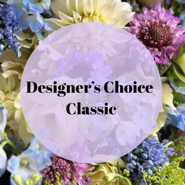 Designer’s Choice Classic floral arrangement with blue, purple, and cream blooms