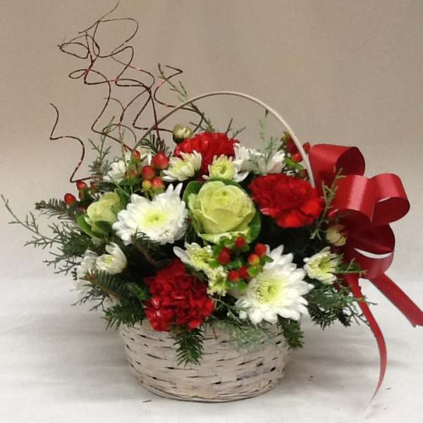 Basket arrangement of red and white flowers with a red ribbon bow