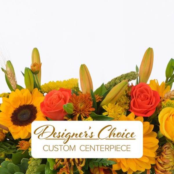 Bright mixed flower centerpiece with sunflowers, roses, and lilies