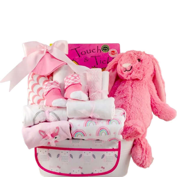 Pink gift basket with a plush bunny and wrapped baby items