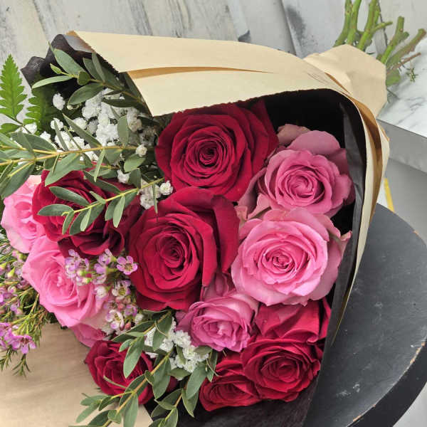 Bouquet of red and pink roses wrapped in paper