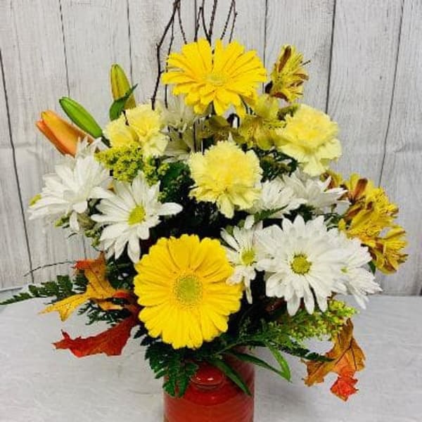 Yellow and white daisy bouquet in a red-orange vase