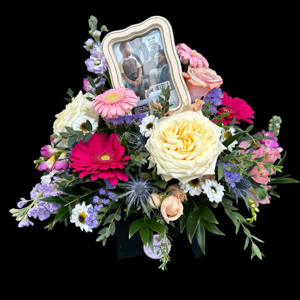 Mixed flower arrangement with a framed photo centerpiece