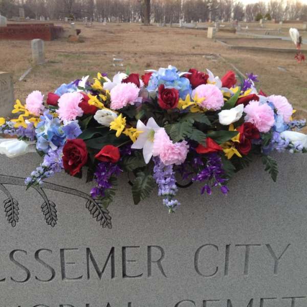 Colorful floral arrangement on a cemetery monument