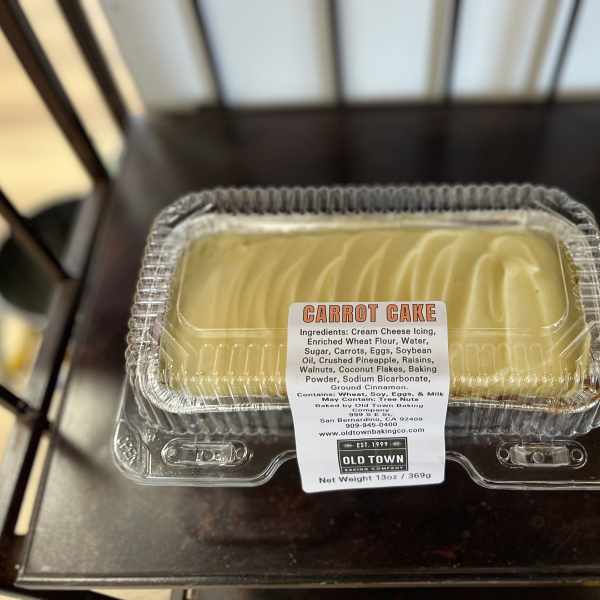 Carrot cake in a clear plastic clamshell container