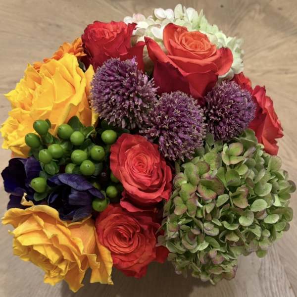 Colorful bouquet of roses, purple allium, and hydrangea blooms