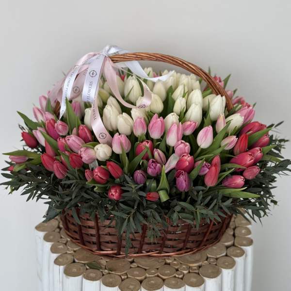 Basket of pink and white tulips with a ribbon bow