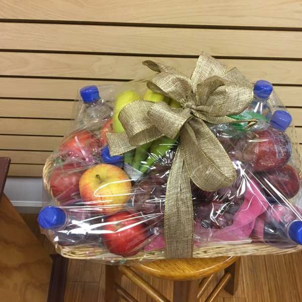 Fruit basket wrapped in plastic with a gold bow