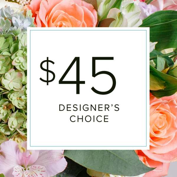Designer’s choice floral arrangement with peach roses and pale green hydrangea