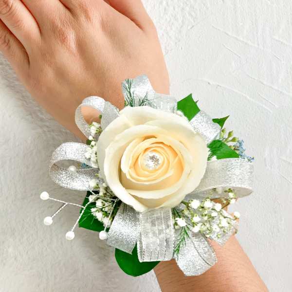 Cream rose wrist corsage with silver ribbon and baby's breath